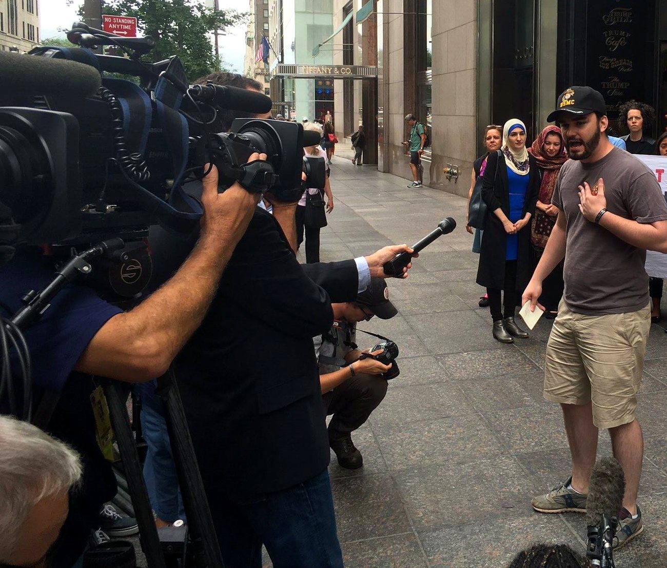 Alexander McCoy speaking to a bank of television cameras