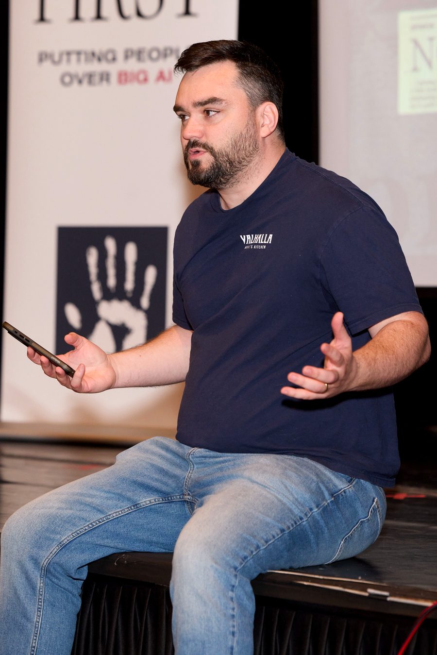 Alexander McCoy speaking at a town hall about AI